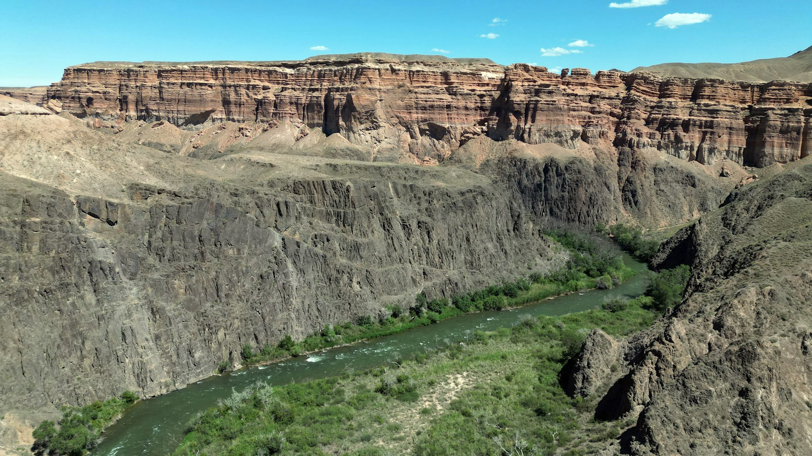 A winding river between the rocky walls of Charyn Canyon