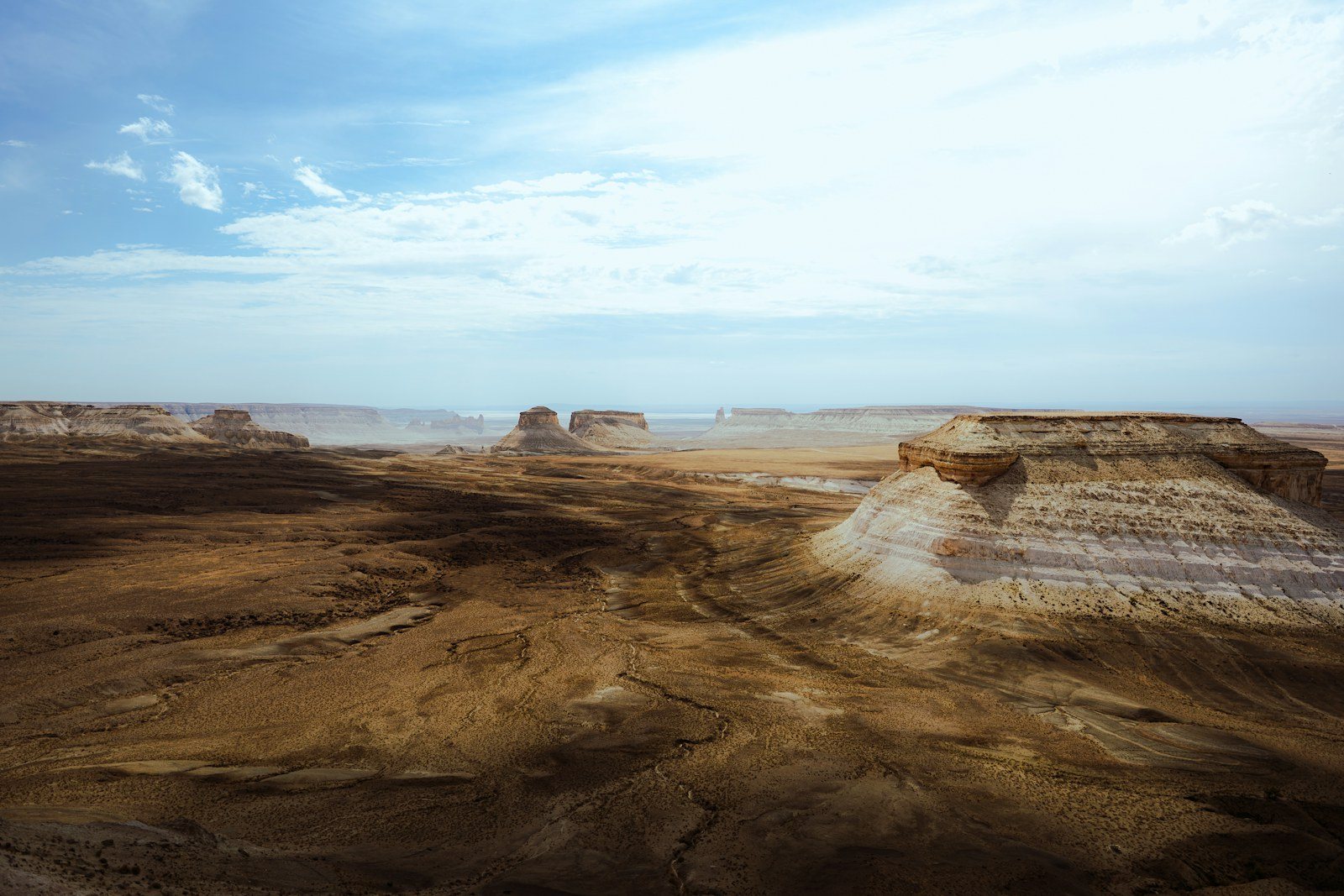 Wide desert plateaus and flat-topped rock formations